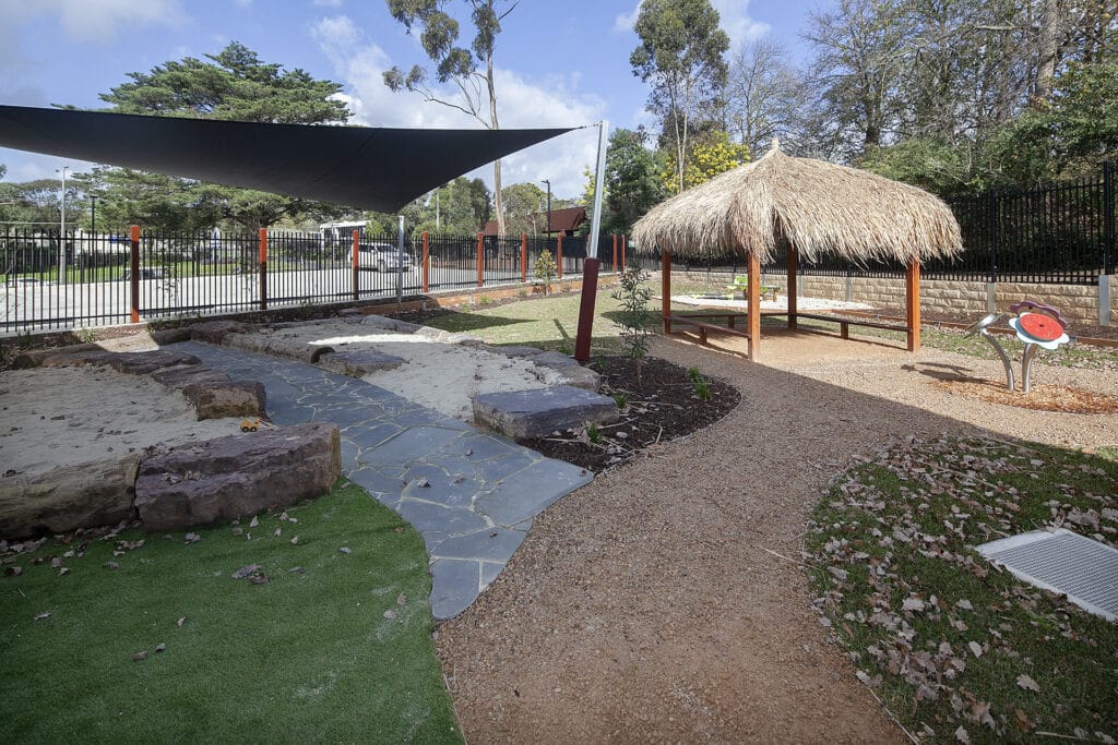 Outdoor play area with hut