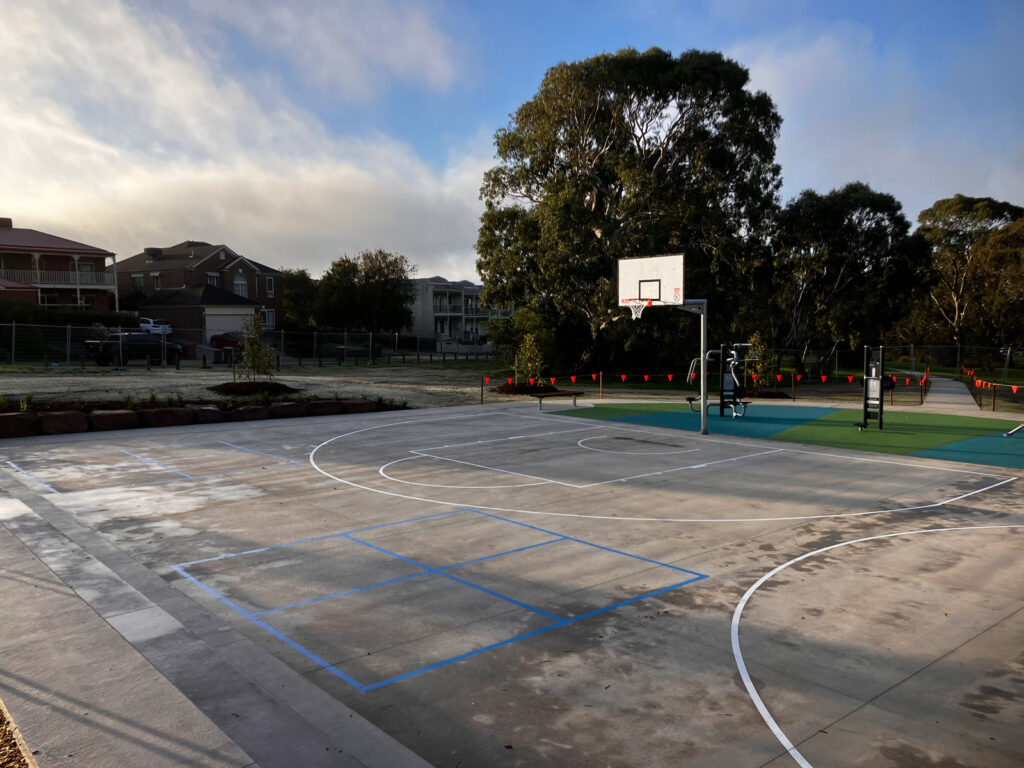 Outdoor basketball court with trees