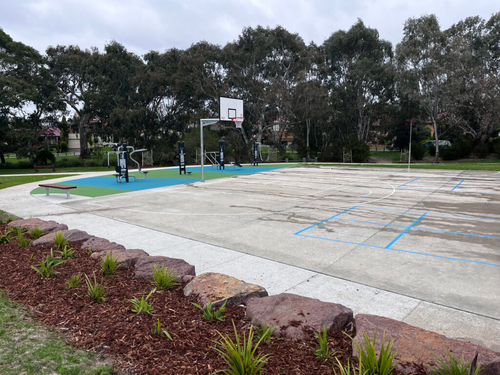 Outdoor basketball court with trees