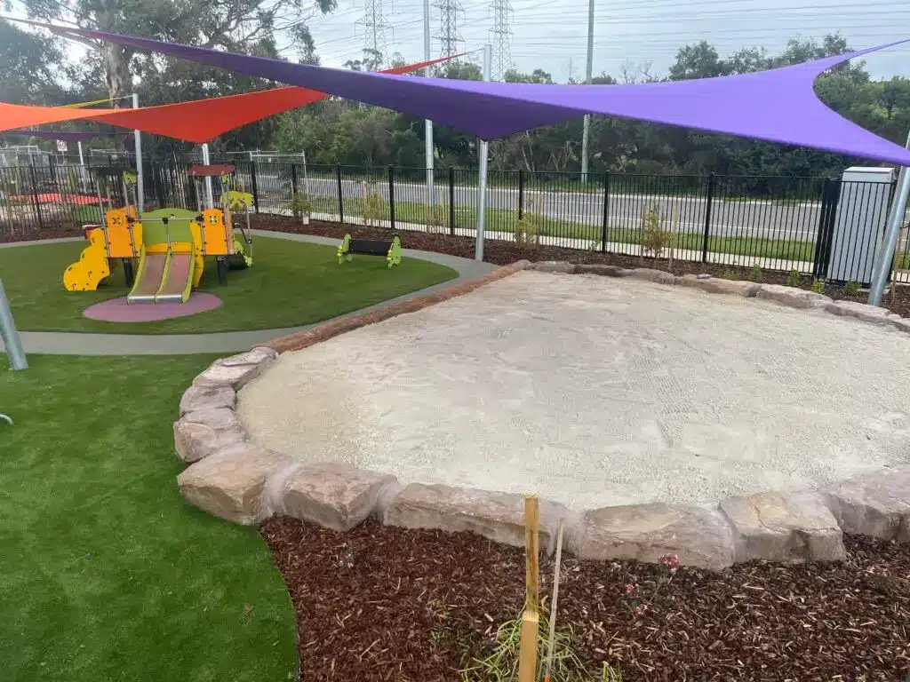 Playground with sandpit and shade.